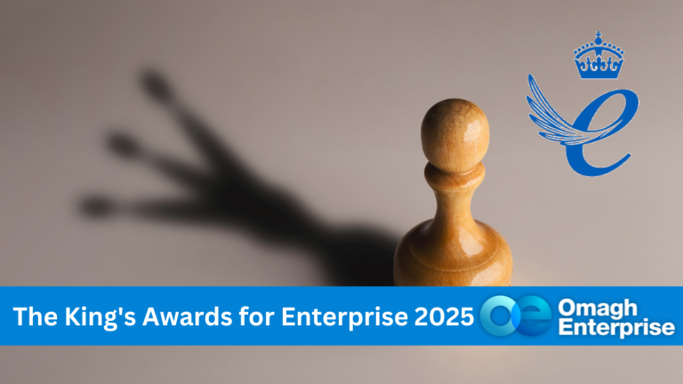 A chess rook piece, casting a shadow the king piece. The King's Award of Enterprise logo. Blue banner along the banner. White text "The King's Awards for Enterprise 2025" Omagh Enterprise logo within the banner.